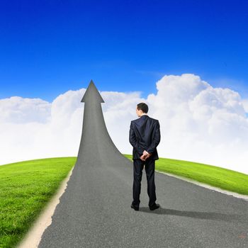 Concept of the road to success with a businessman standing on the road