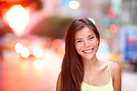 Asian girl city portrait. Woman smiling outside in evening light on Manhattan, New York City. Beautiful young mixed race Asian / Caucasian woman.