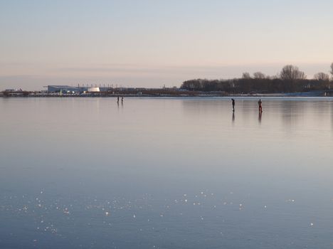 people walking on frozen lake in copenhagen, denmark