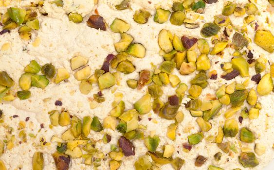 Halva with pistachios, background closeup