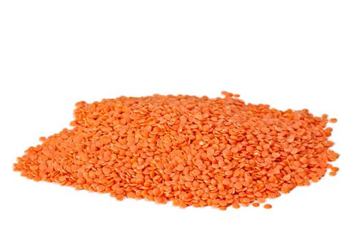 Red organic lentils on white background with light shadow