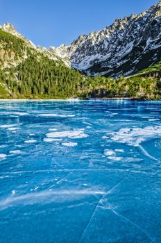 Mountain ice lake with cracked textured ice, High Tatras, Slovakia