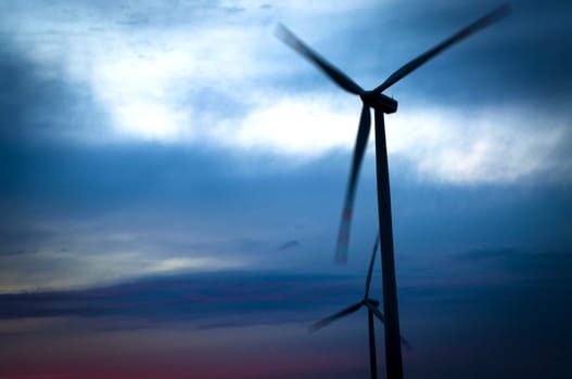 An image of windturbine against amazing sunset