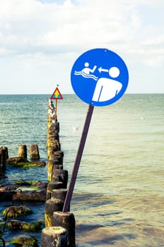 An image of the beach and sign on it
