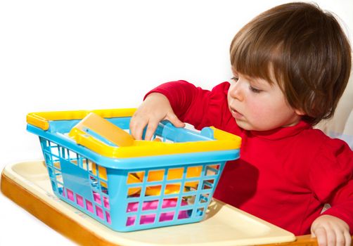 Little girl playing with colored toys