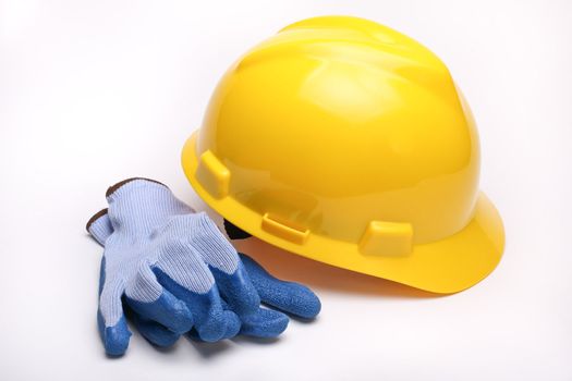 A yellow hard hat and blue gloves