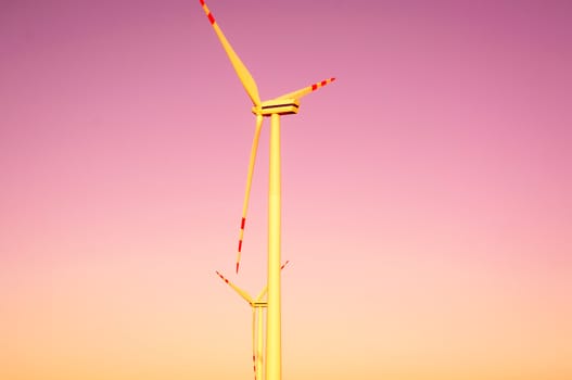 An image of windturbines at dusk