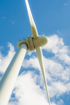 An image of windturbines against blue sky