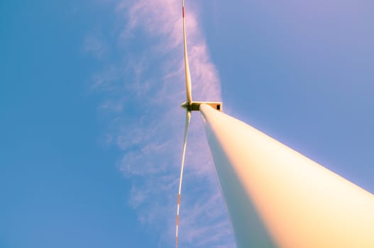 An image of windturbines against blue sky