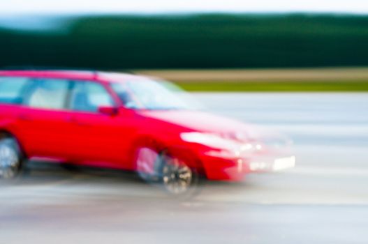 An abstract image of drunk driver driving red car