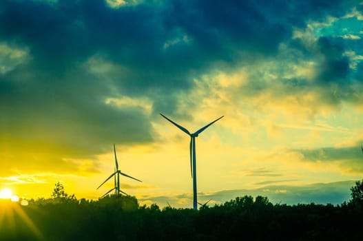 An image of windturbine during beautiful sunset