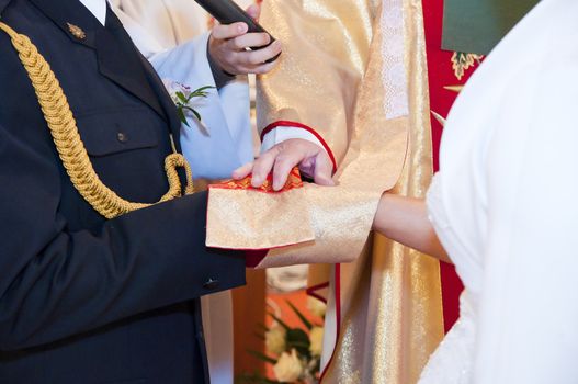 An image of priest given blessing to new couple