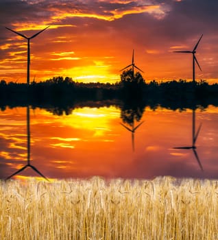 A silhouette of windturbines on a amazing sunset