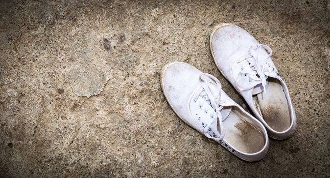 An image of old white dirty shoes