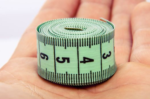 An image of green centimeter on white background