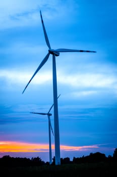 An image of windturbine against amazing sunset