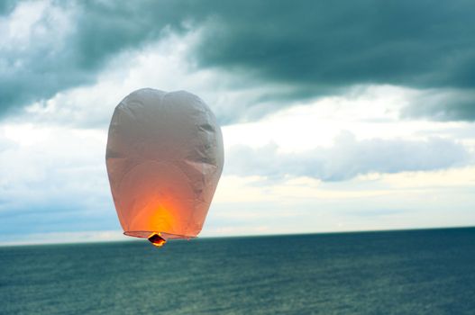 An image of hot air balloon over the sea