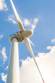 An image of windturbines against blue sky