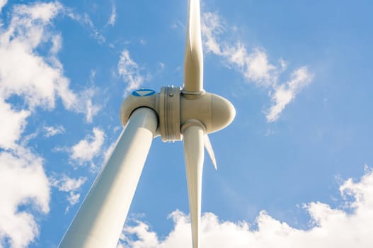 An image of windturbines against blue sky