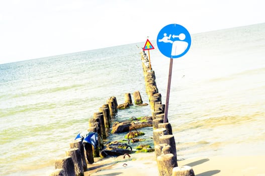 An image of the beach and sign on it