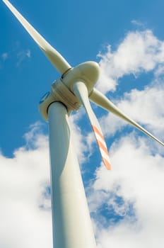 An image of windturbines against blue sky