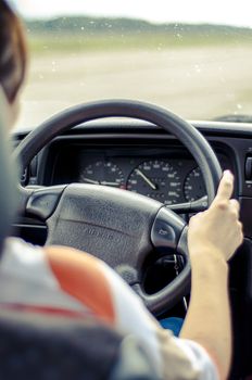 Hands of a female driver on steering wheel