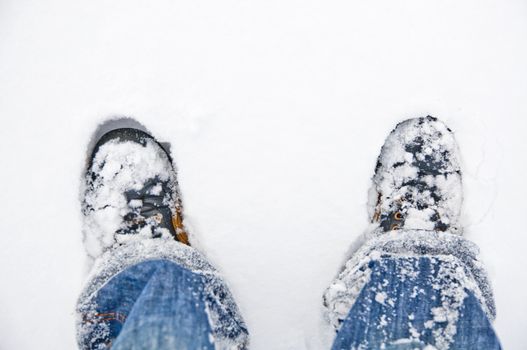 An image of boots in the snow