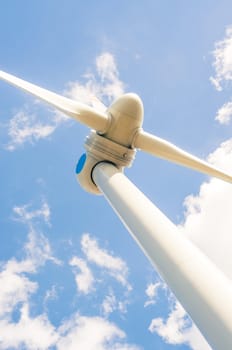 An image of windturbines against blue sky