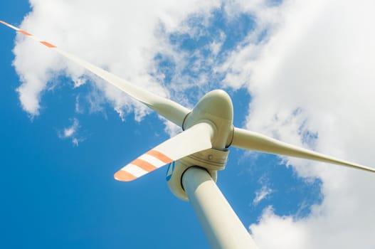 An image of windturbines against blue sky