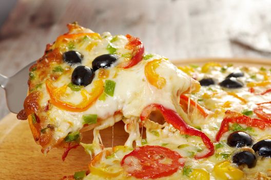 home pizza with tomato and eggplant  Closeup .taking slice of pizza,melted cheese dripping