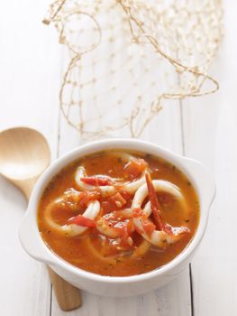 close up of a bowl of calamari seafood soup