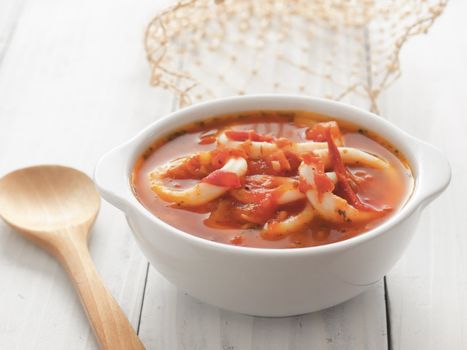 close up of a bowl of calamari seafood soup