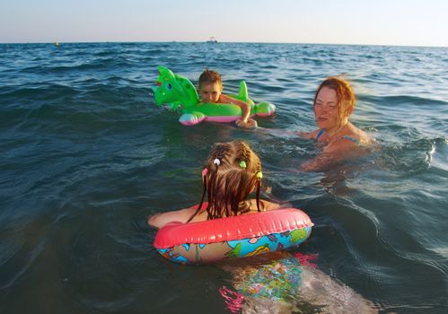 family in the waves on the sea beach