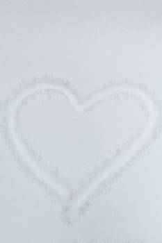 Heart drawn in the snow - a symbol of love and valentine