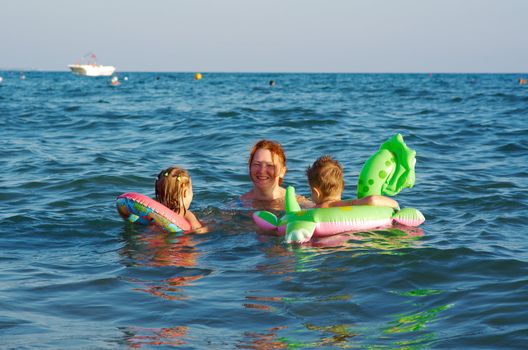 family in the waves on the sea beach