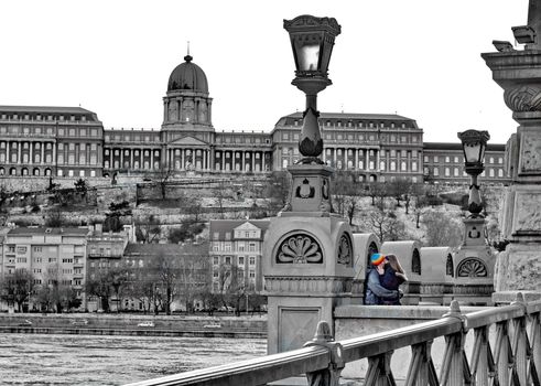 Young couple kissing on the famous bridge of Budapest