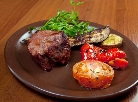 Grilled beef on white plate  with vegetable.closeup