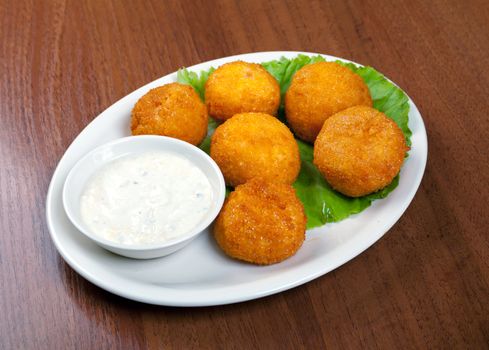 potatoes with sauce on plate.closeup