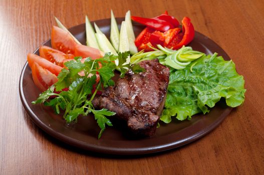 Grilled beef on white plate  with vegetable