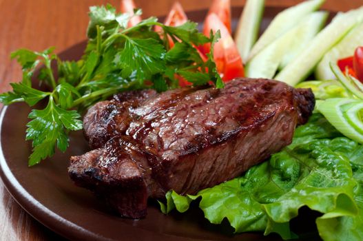 Grilled beef on white plate  with vegetable.closeup