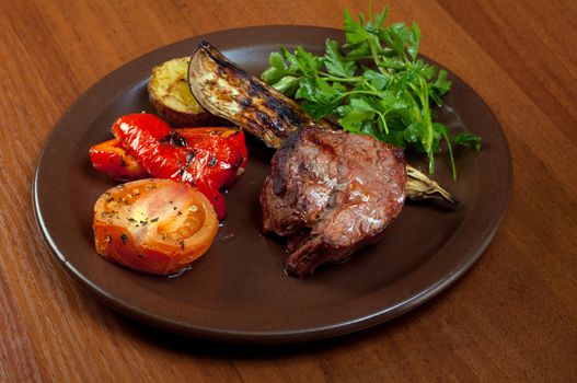 Grilled beef on white plate  with vegetable.closeup