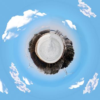 An image of winter scenery with windturbines in the background 