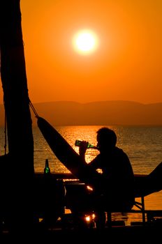 Man drinking a Beer at Sunset
