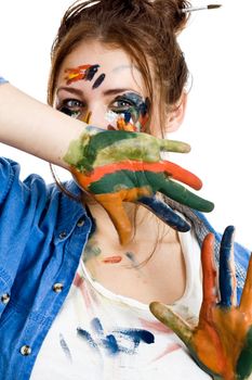 Female artist with paint smeared face and hands isolated on white background