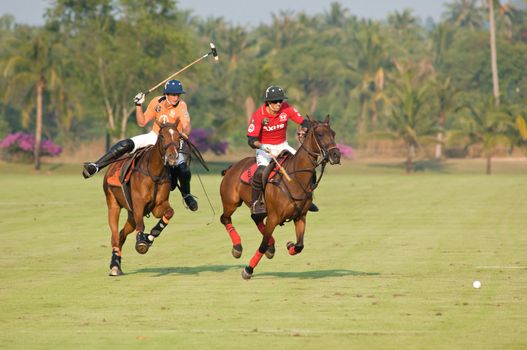 PATTAYA - JANUARY 19: Players fighting for the ball during the final between Thai Polo and Axus Polo at Thai Polo Open on January 19, 2013 in Pattaya, Thailand.