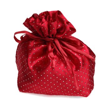 Red gift back with sparkling dots against a white background.