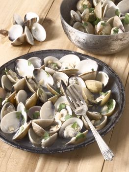 close uo of a plate of white clams in white wine sauce