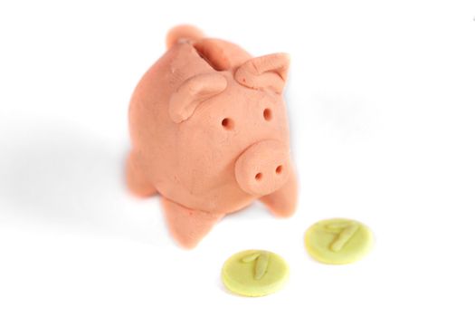Piggy bank and coin on a white background