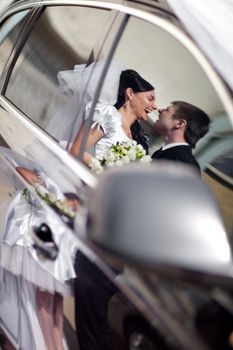 kiss in the reflection of a car