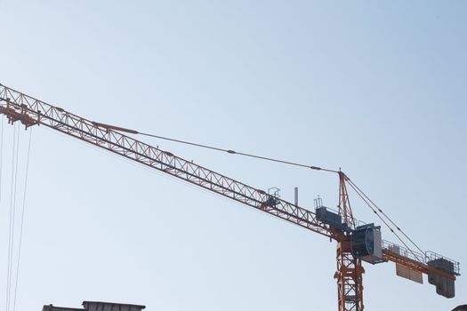 The elevating crane on construction of a building